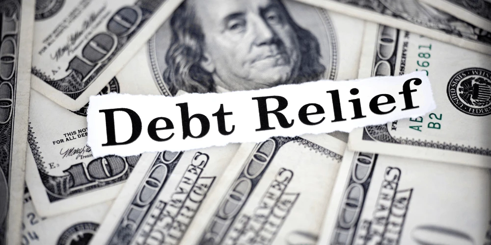 Debt relief text over U.S. dollar bills, illustrating common questions about debt relief options, myths, and real outcomes.