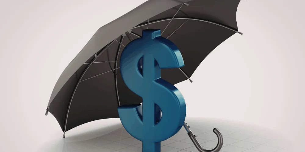 Dollar sign under umbrella, symbolizing financial protection and building a safety net through consistent savings