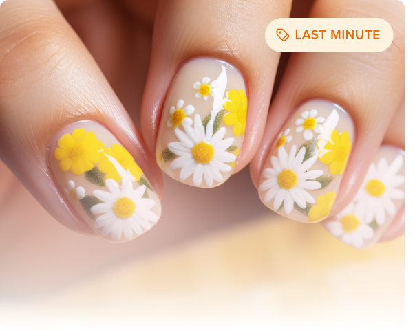 Close-up of fingernails with yellow and white daisy floral nail art on a neutral base.