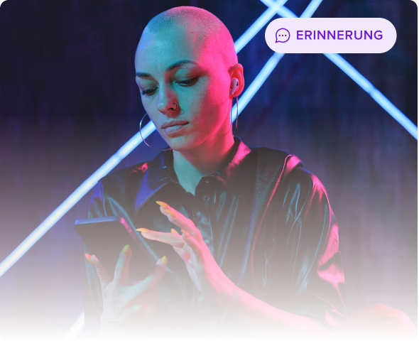 Person with a shaved head and earphones using a smartphone against a dark background with blue neon light lines.