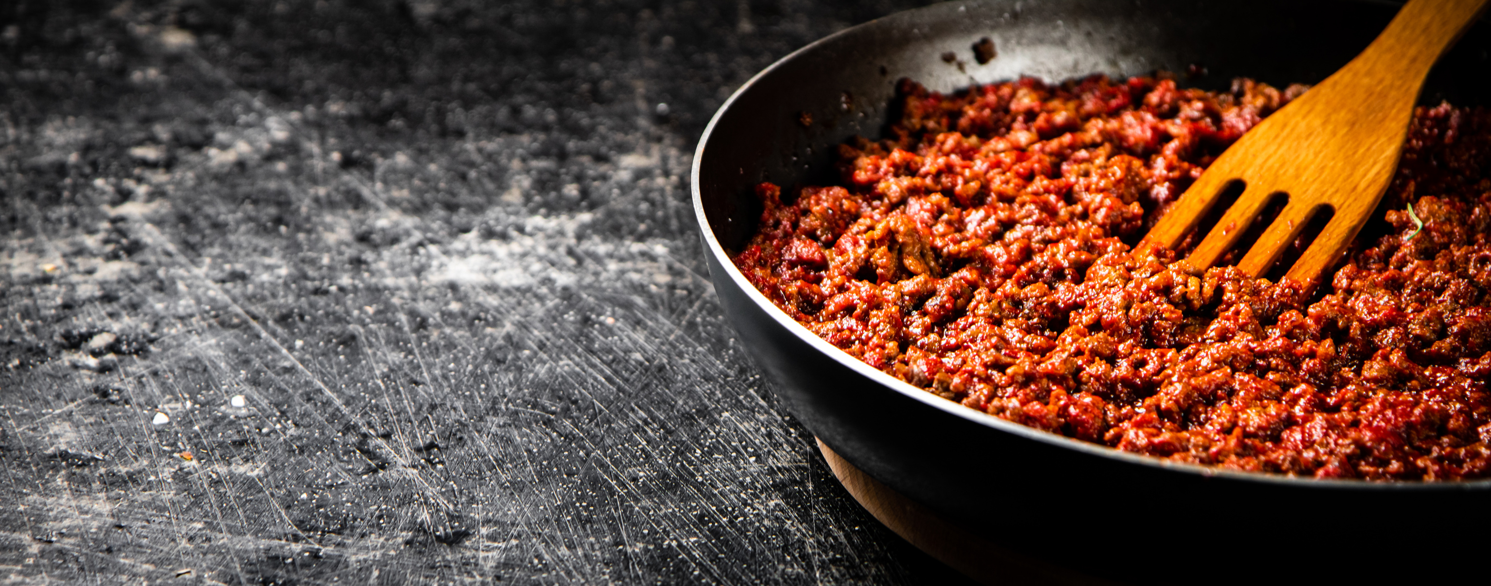 Bolognese sauce simmering in a pan