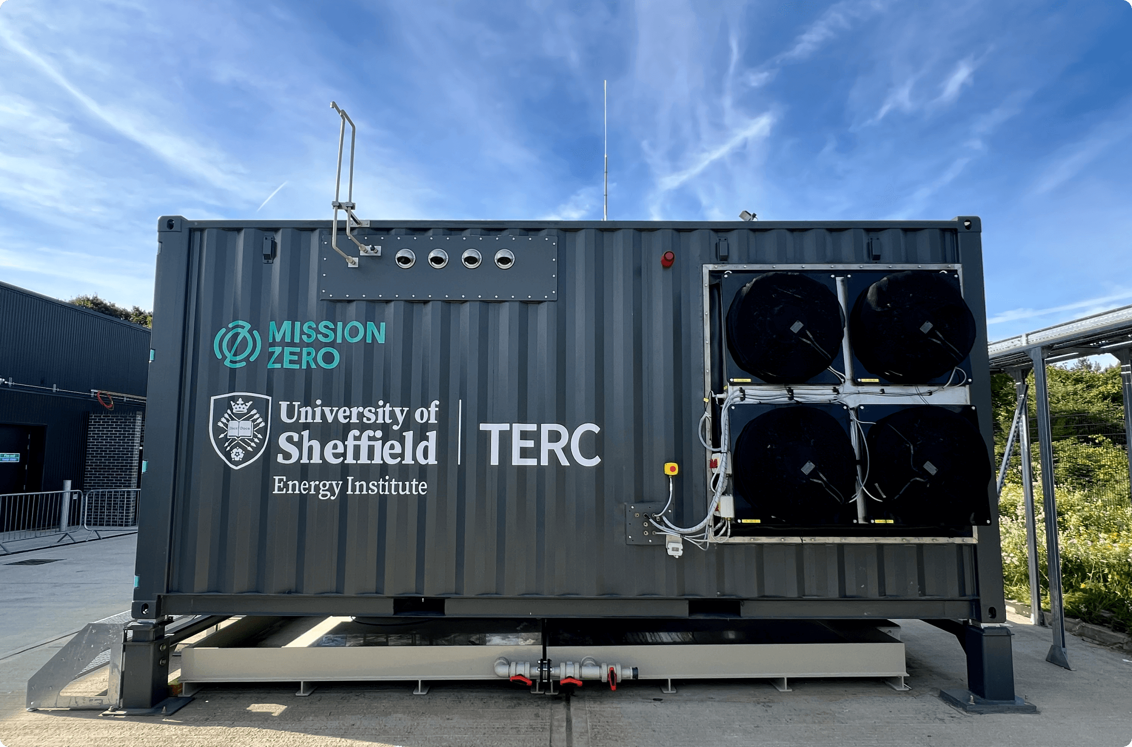 A direct air capture unit made from a shipping container with fans built into the side of the container.