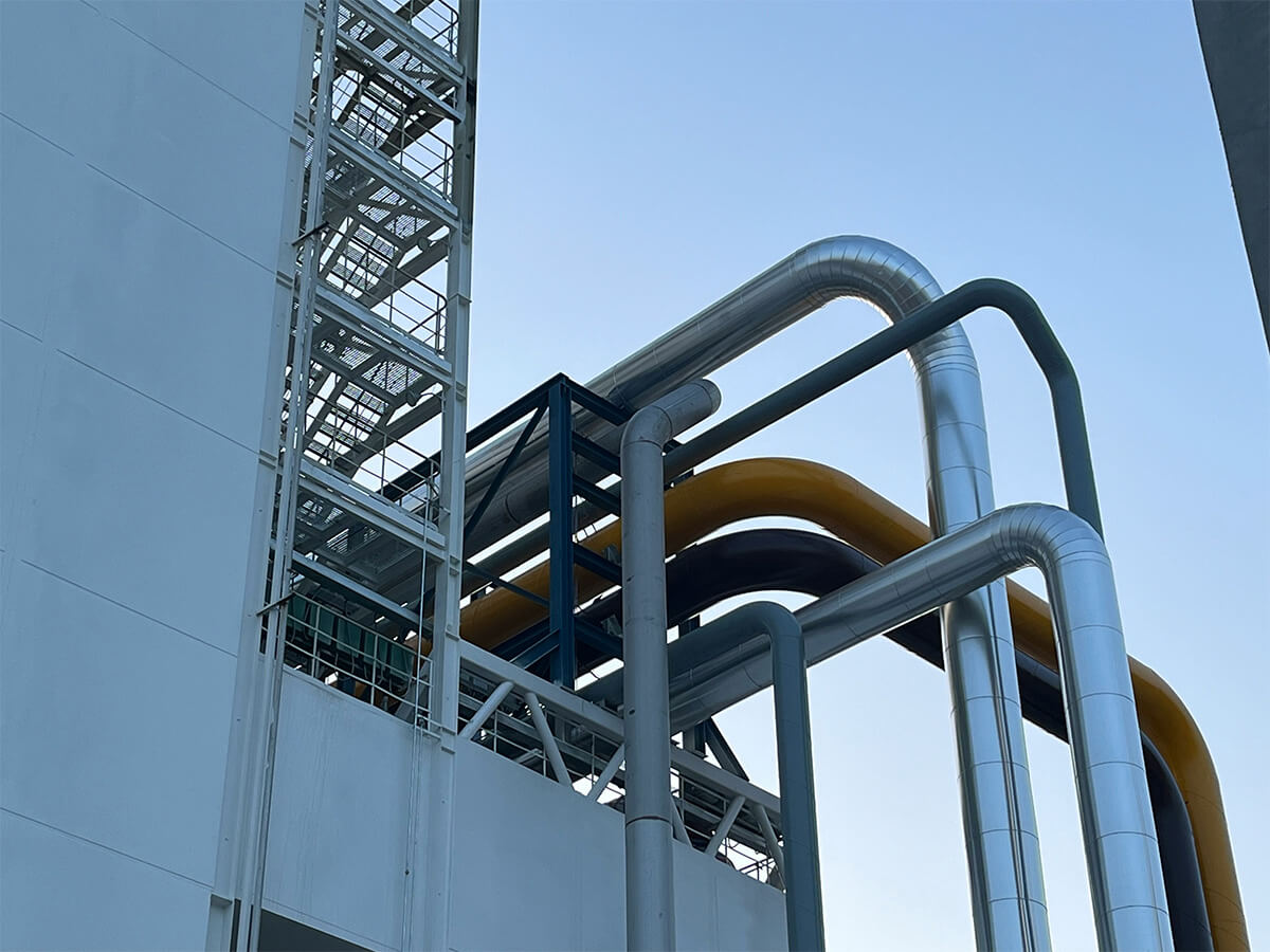 Industrial pipework feeding into a factory.