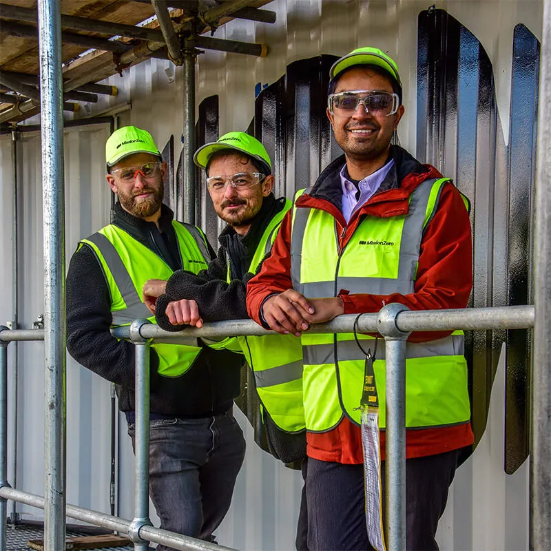 Mission Zero's three co-founders outside a direct air capture unit.