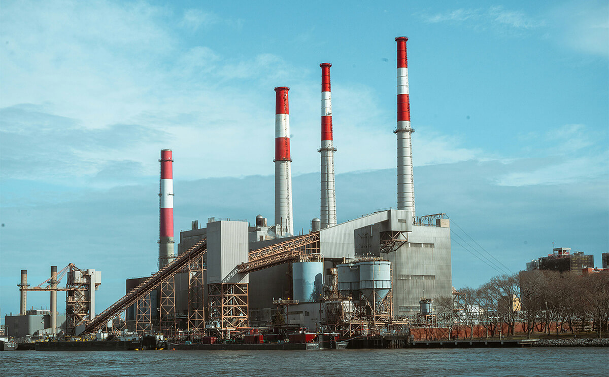 Factory next to a body of water.