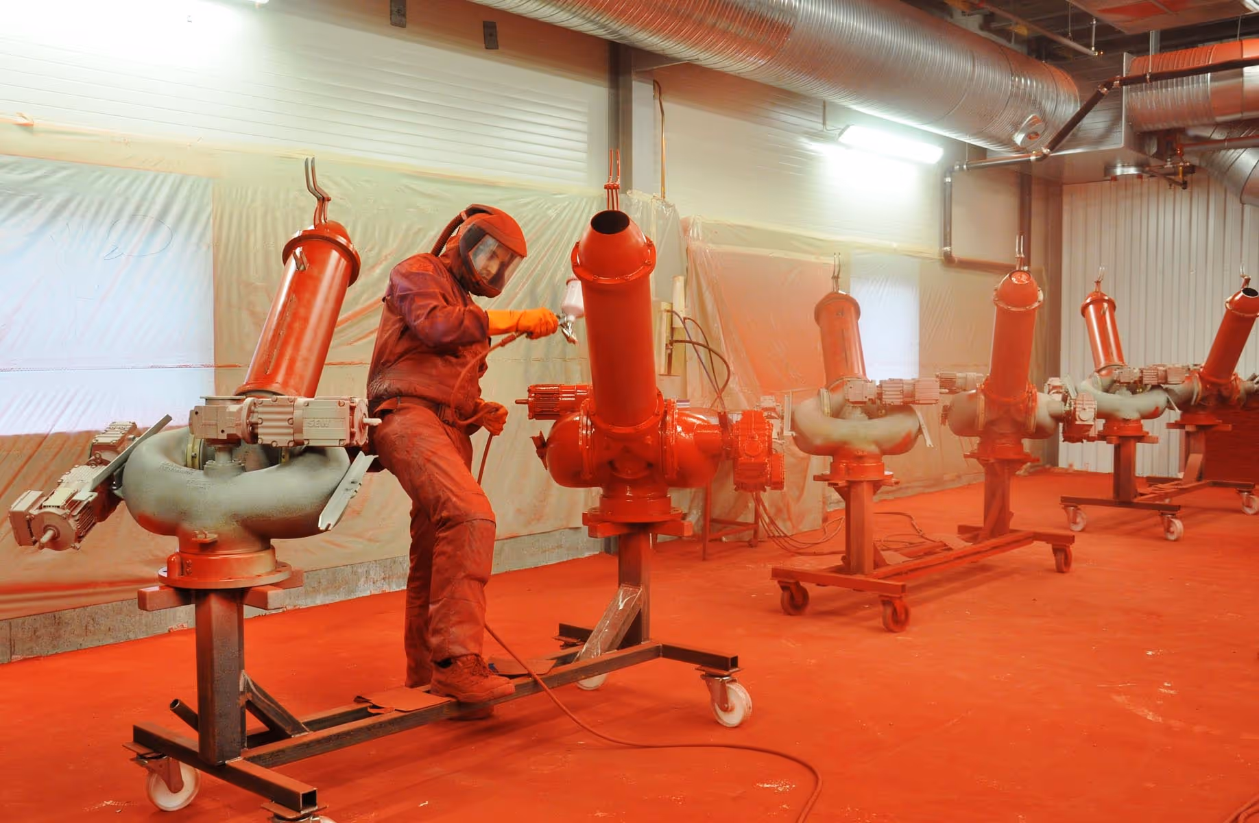 One of our workers spray painting our pumps