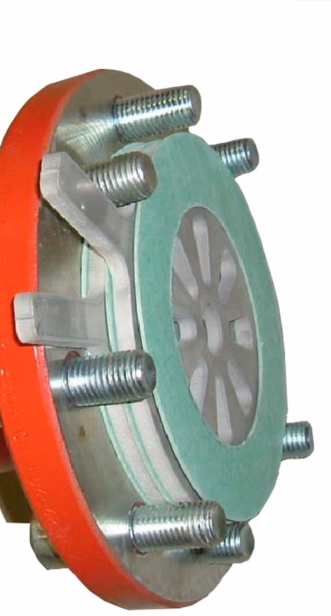 Close-up of a mechanical flange assembly with bolts, a green gasket, and a red outer ring.