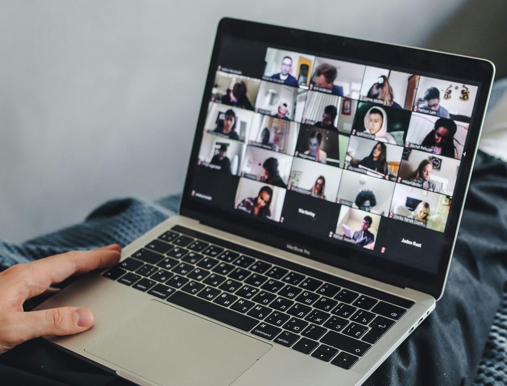 A laptop screen showing 25 different people participating in an online training session via zoom