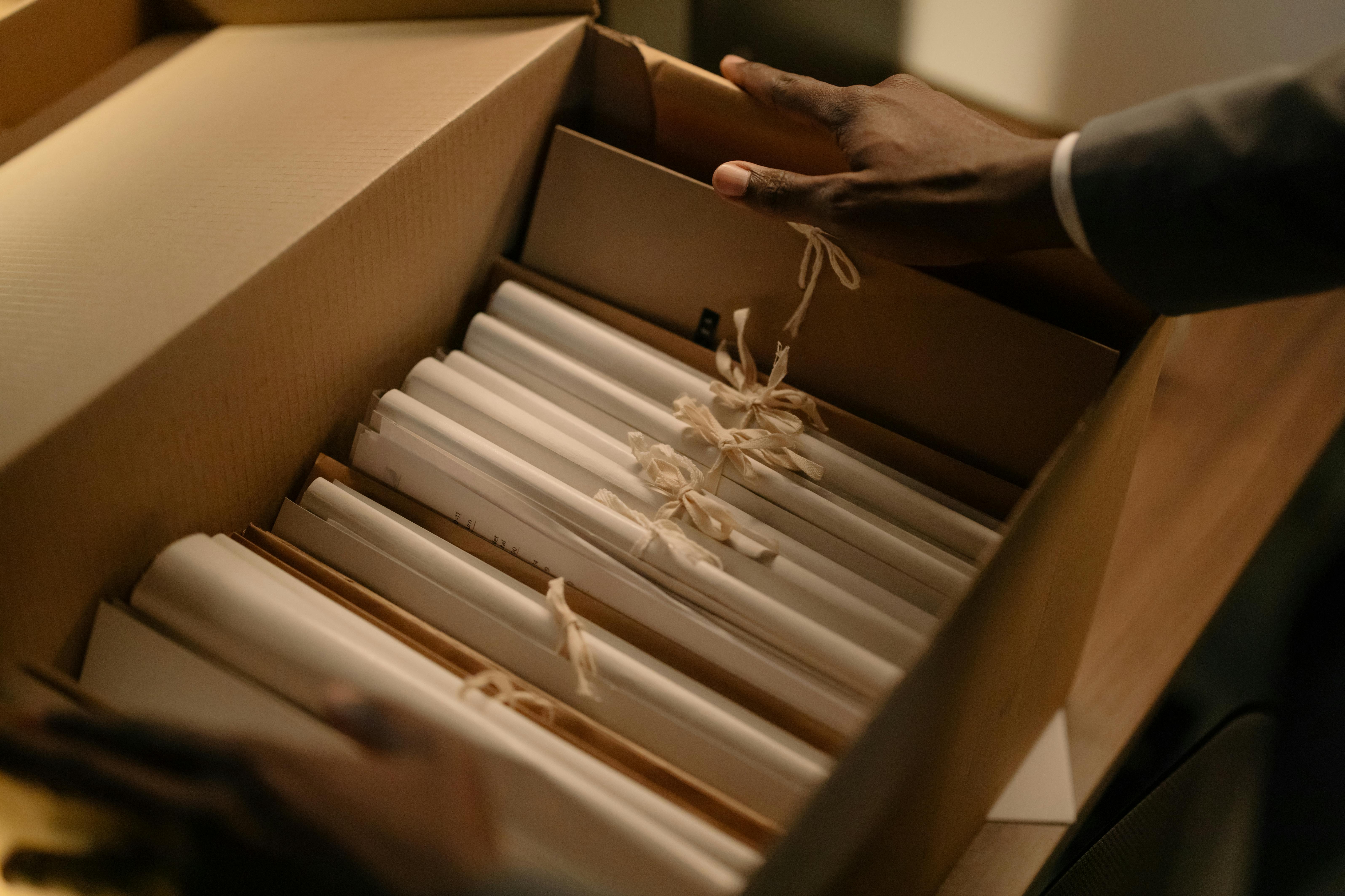 A cardboard box containing records