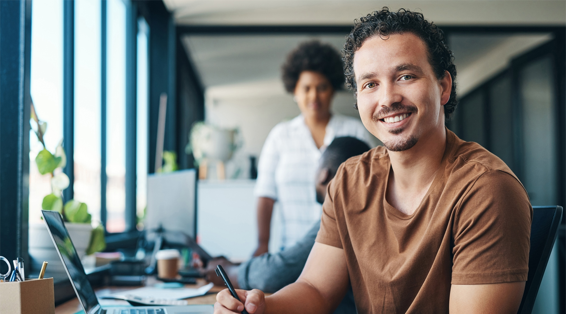 Young professional writing in a notebook as part of a daily mental wellness practice