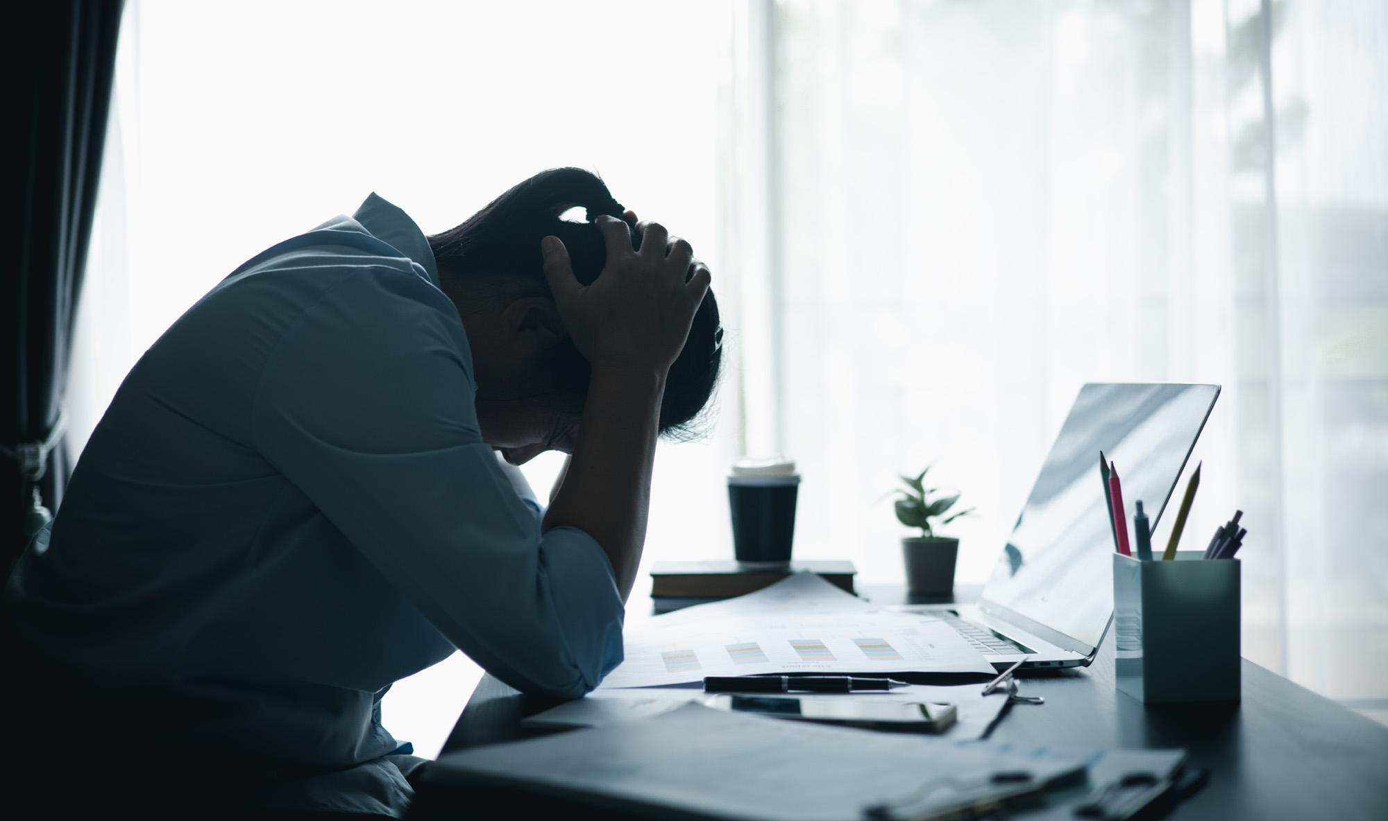 Employee accessing mental health support through a wellness app on their phone during the workday