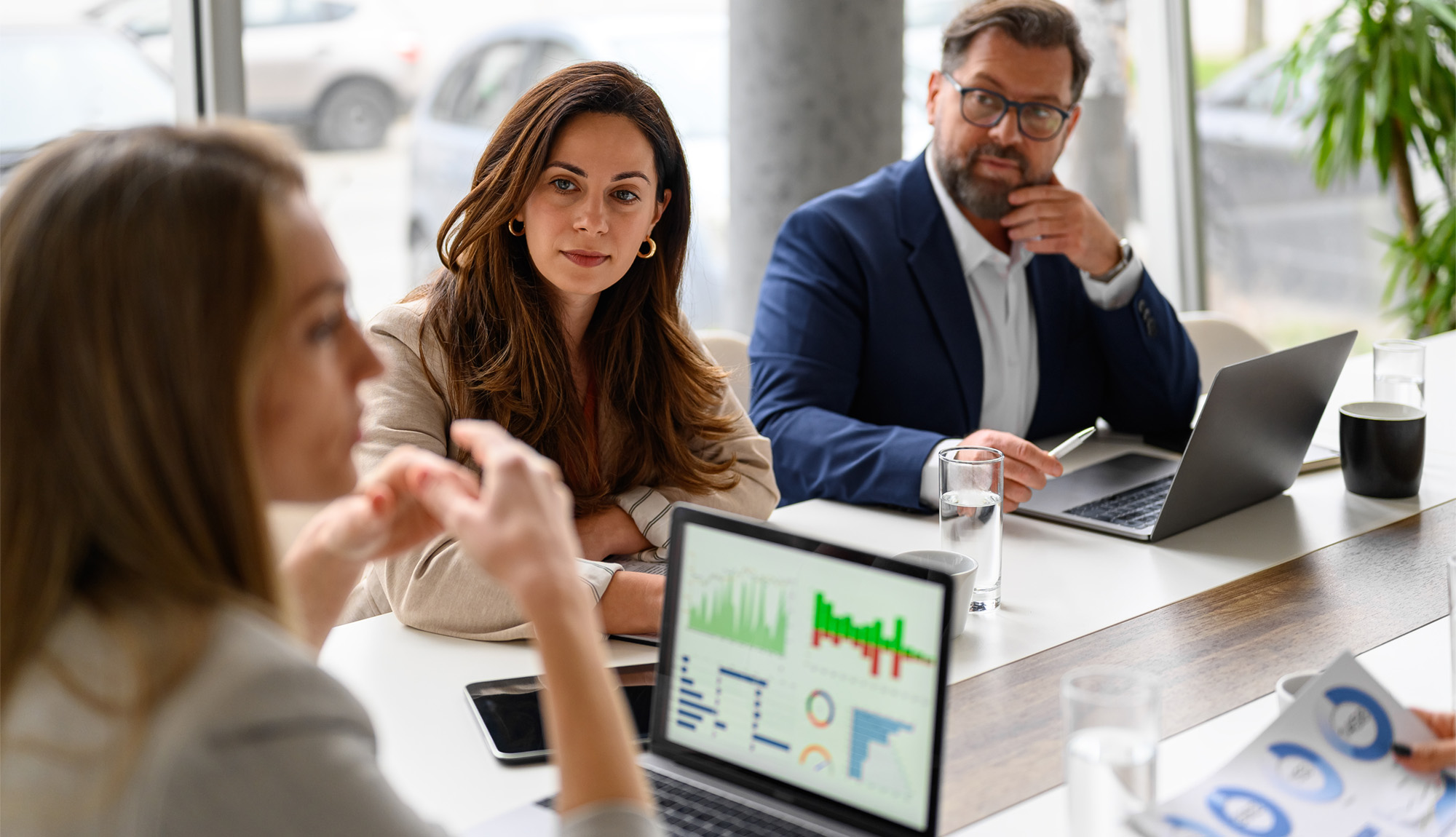 HR leaders in a boardroom reviewing mental health benefits data and workplace claims trends