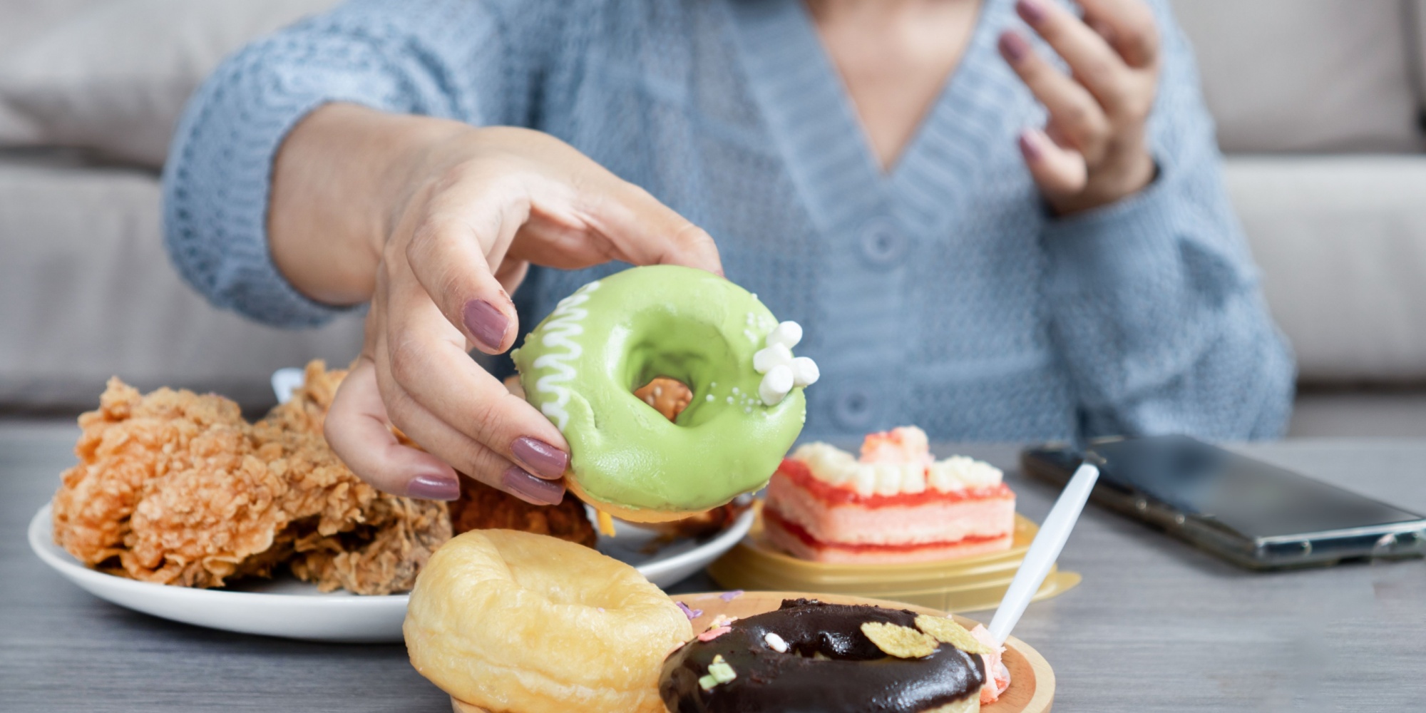 Person pausing to reflect on hunger cues and emotional triggers before eating