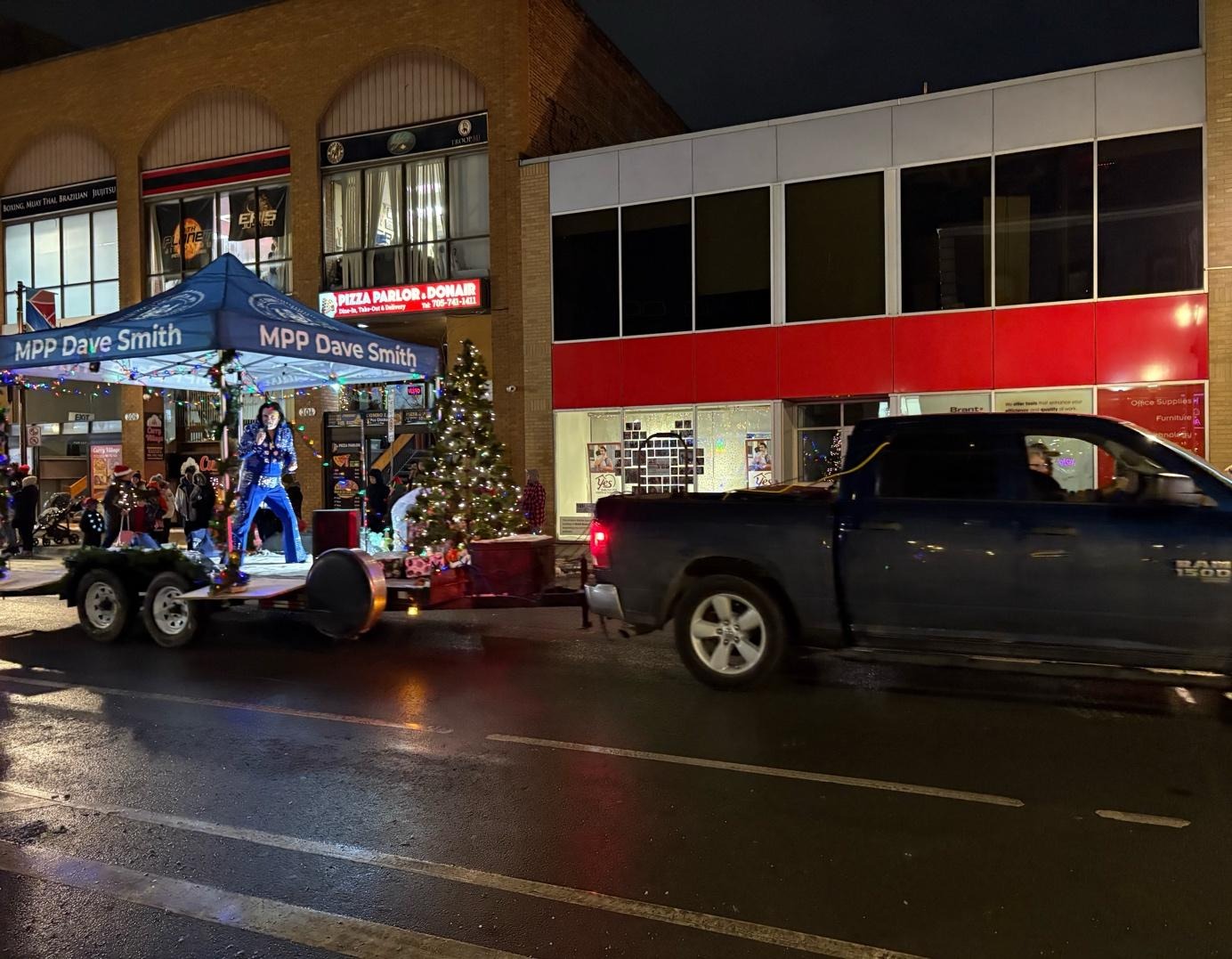 A truck pulling a vehicle with a person on itAI-generated content may be incorrect.