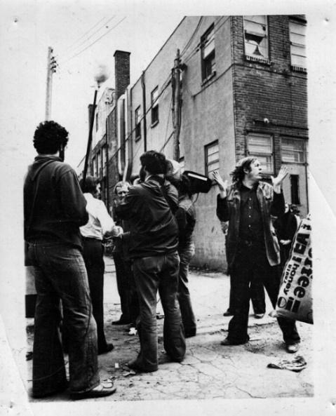 A group of people outside a buildingDescription automatically generated