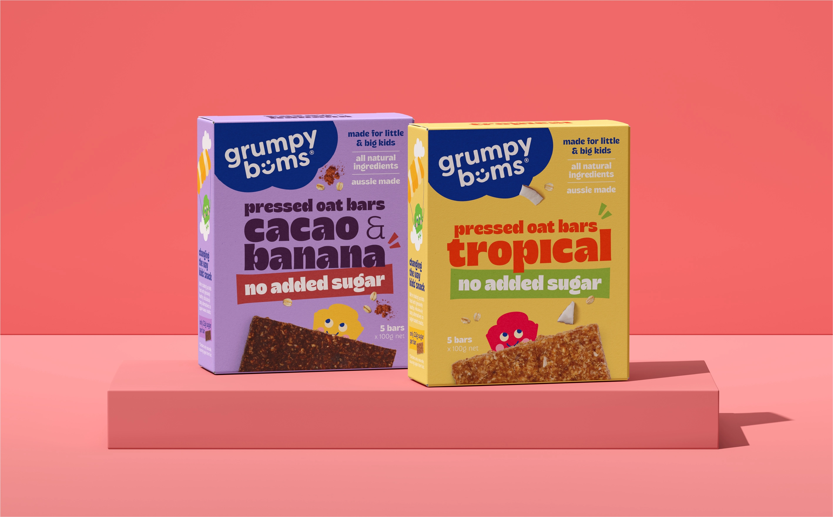 WeAreDepot Packaging Design, Grumpy Bums Cacao Banana and Tropical pressed oat bar boxes on red display blocks, Australian no added sugar kids snack packaging design