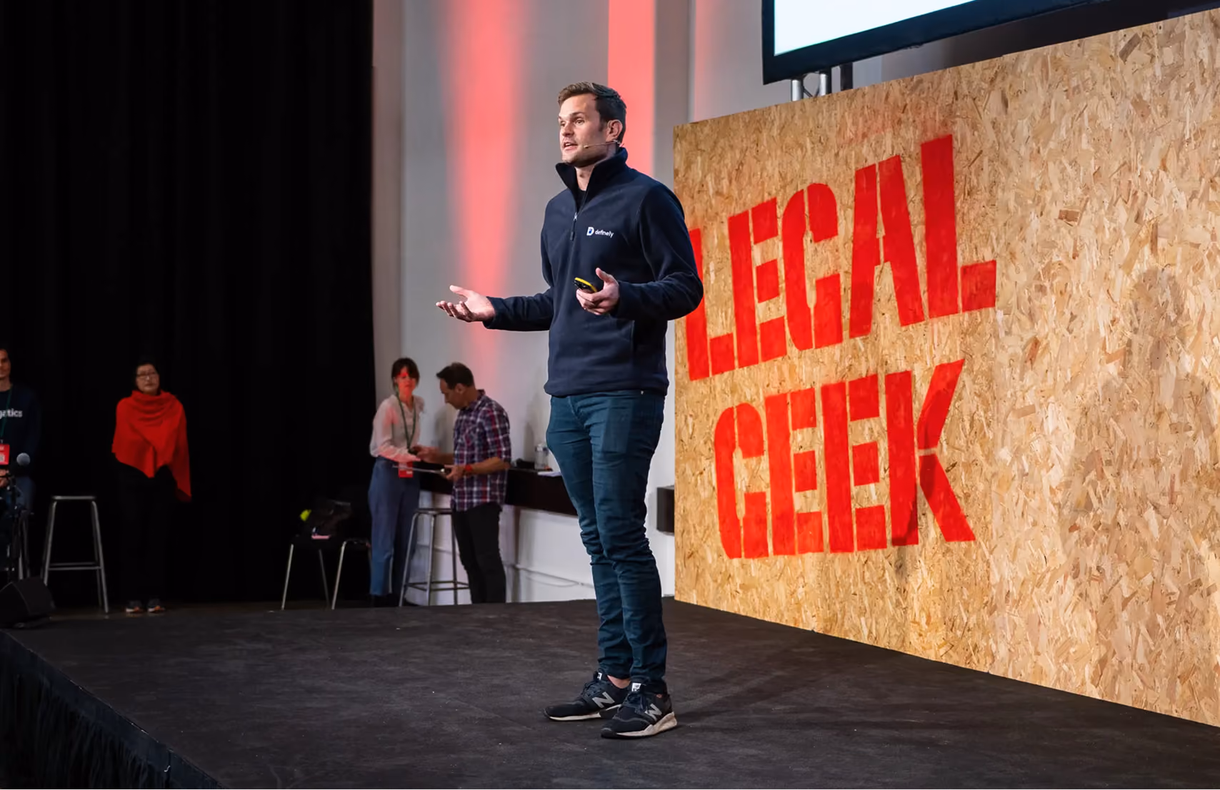 Image of Rhys, presenting on stage at Legal Geek