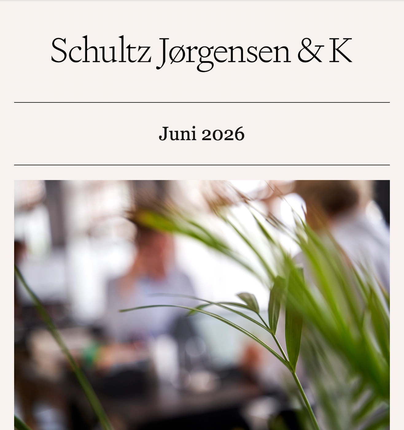 Newsletter cover featuring a collaborative office environment with employees working behind green plants.