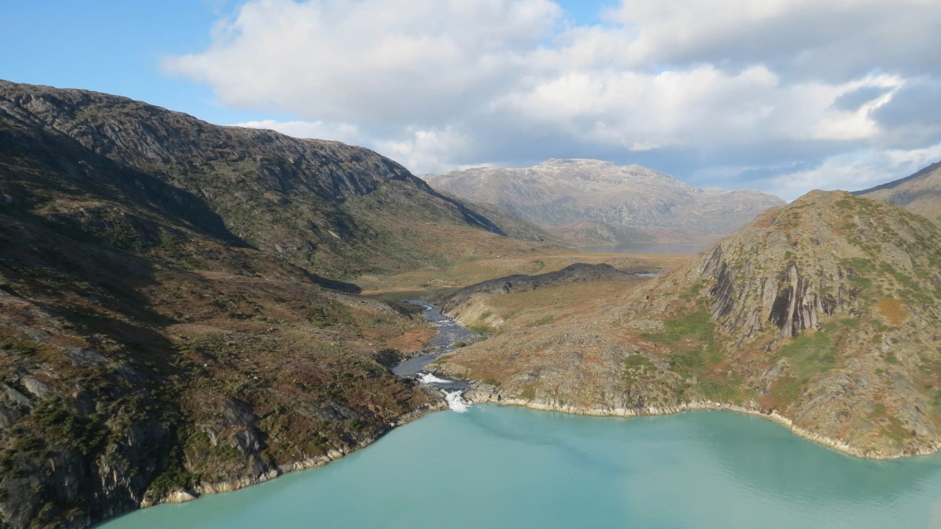 Mountain landscape and turquoise waters near the Majoqqap Qaava project in Greenland.