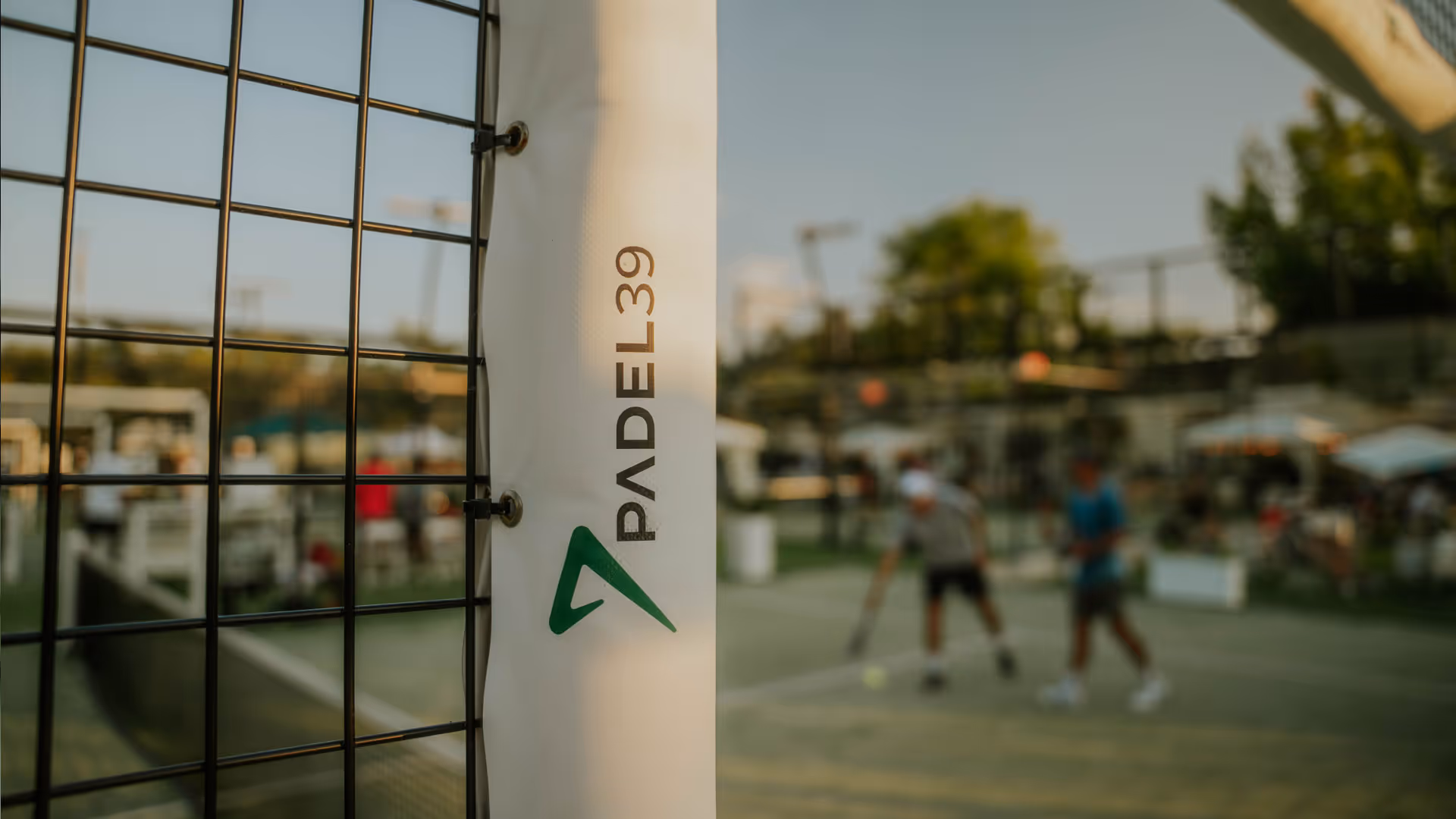 Padel39 padel court with blurred players on the court in the background.