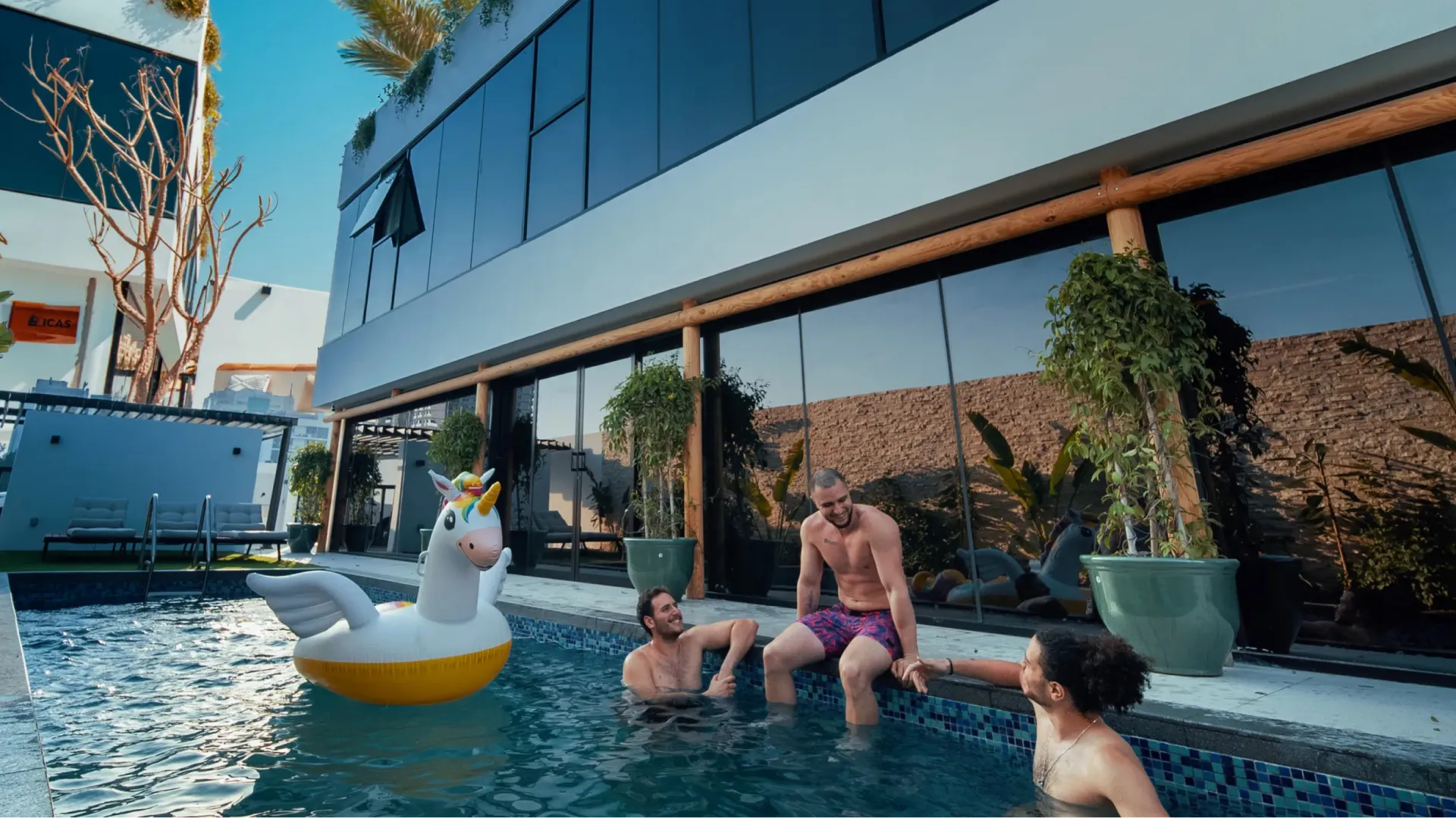 Guests relaxing in a private villa pool