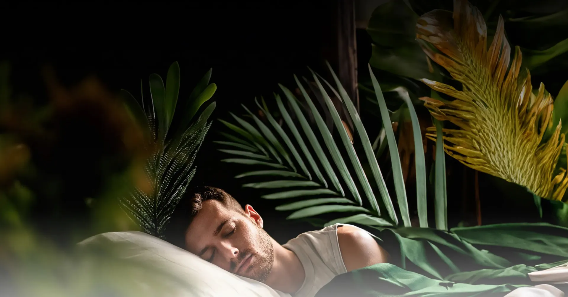 A guest sleeping soundly among lush tropical plants at Nas House