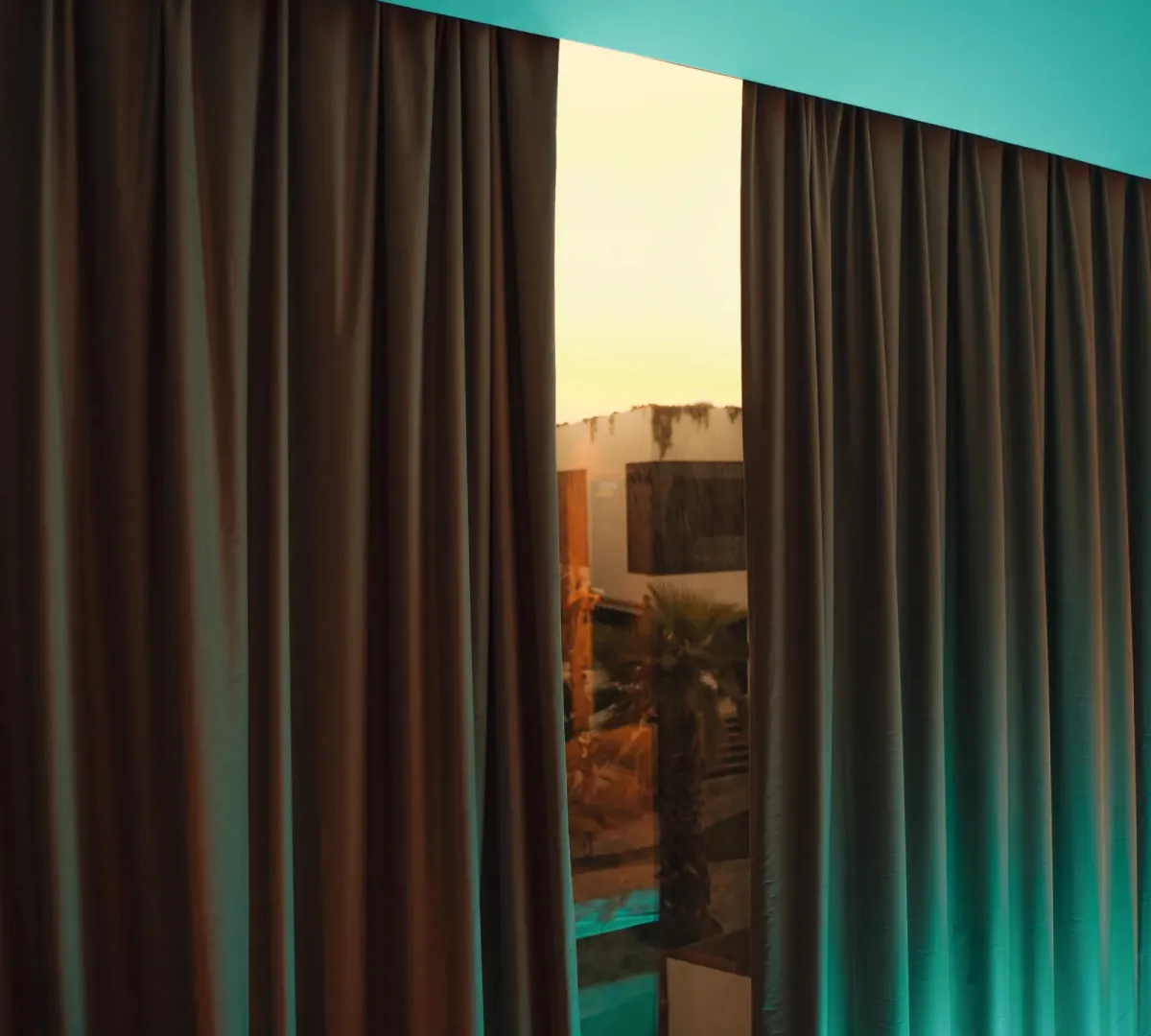 Heavy blackout curtains drawn across a bedroom window
