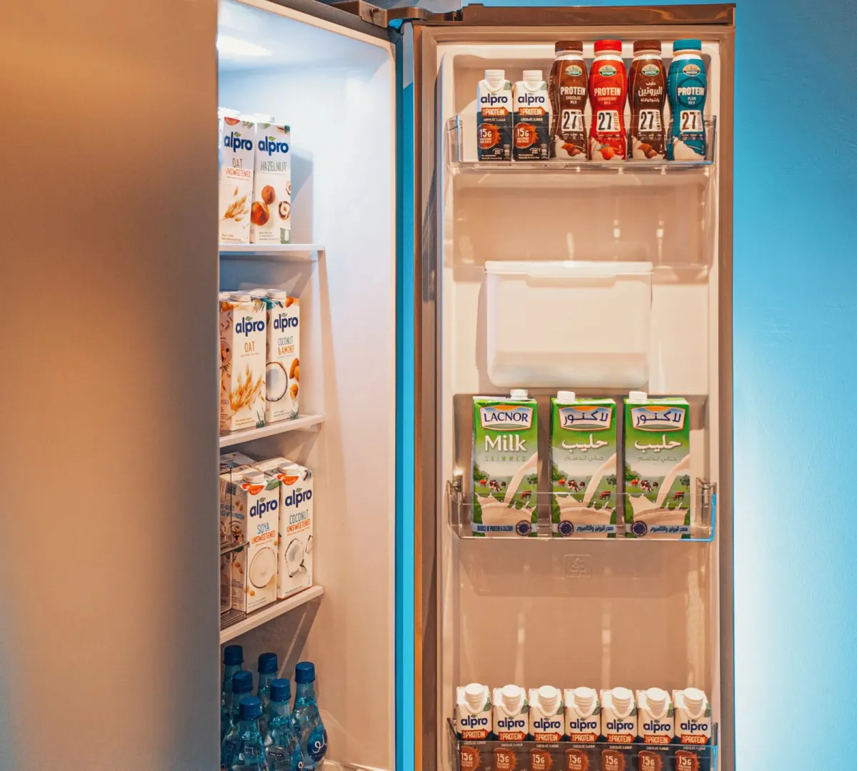 A fridge stocked with protein drinks and healthy snacks