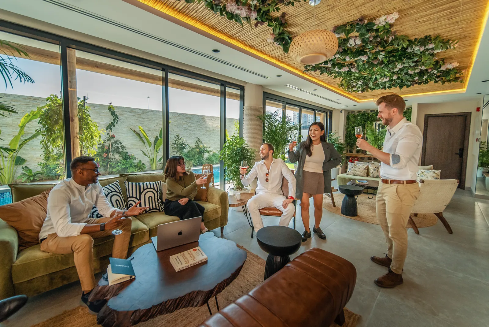 Guests celebrating together in a Nas House villa lounge