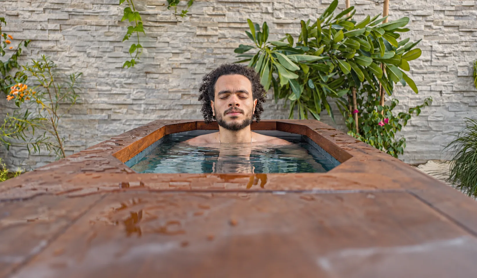 A guest taking an ice bath in the garden