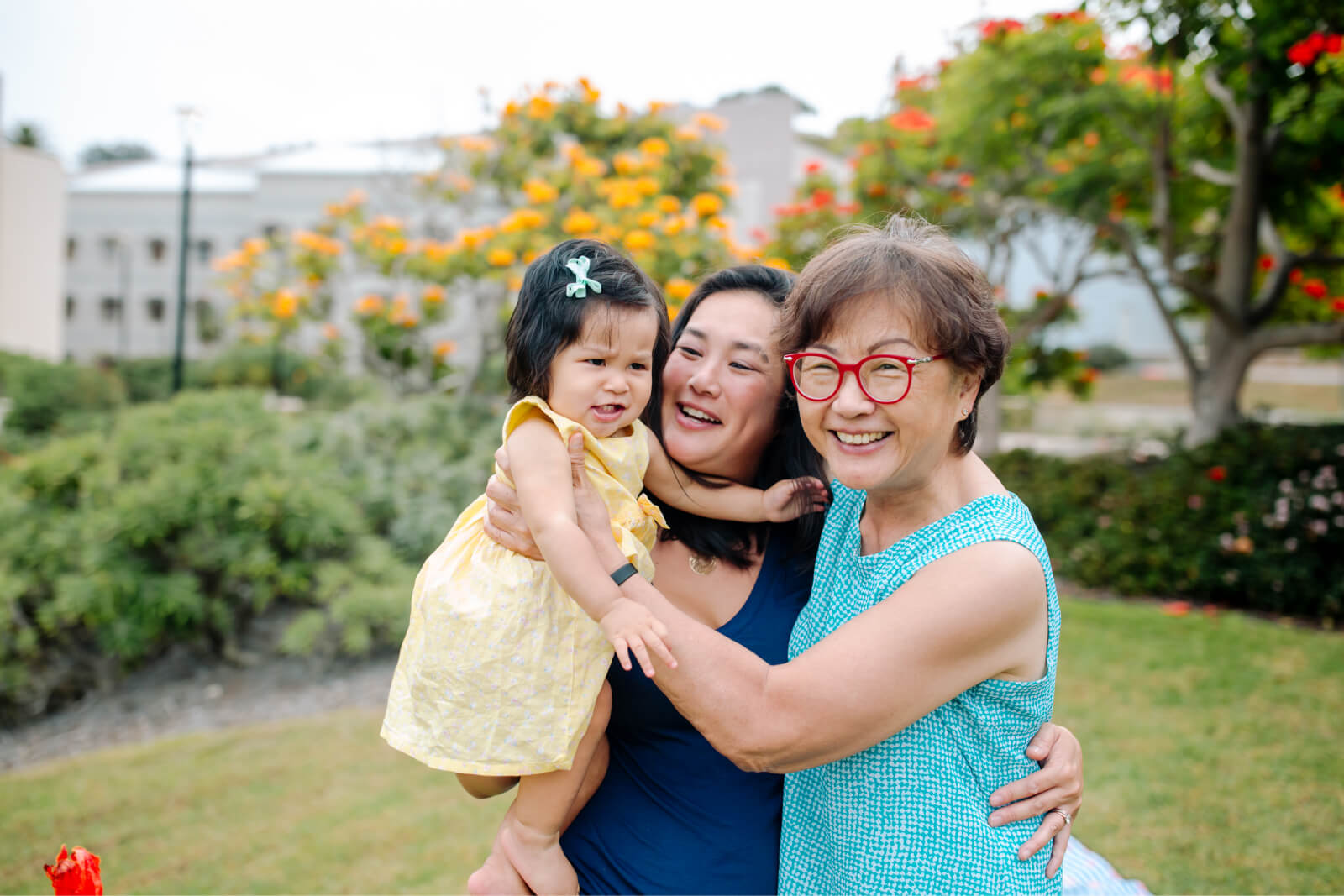 Grandmother, daughter, and young granddaughter outdoors
