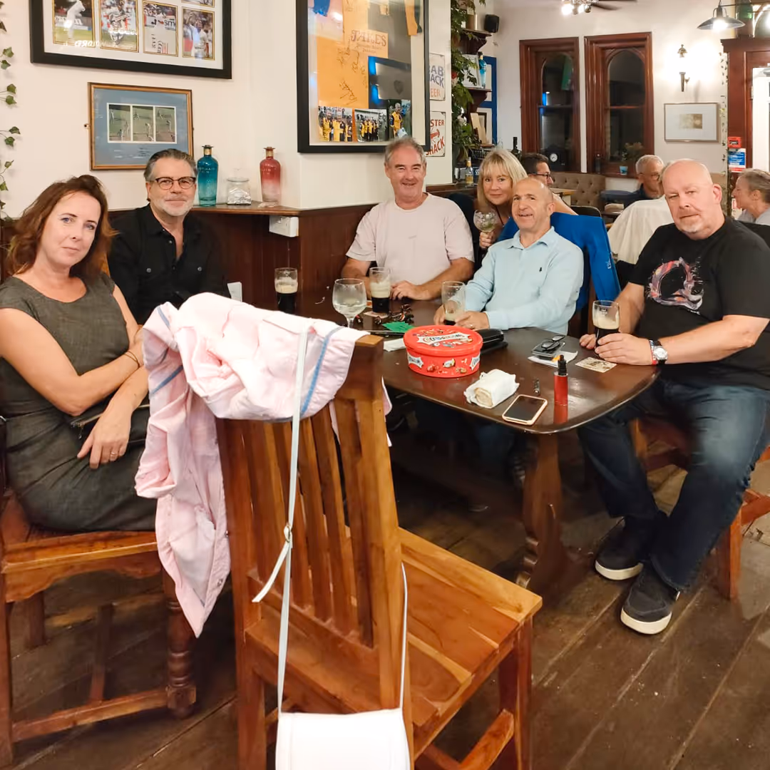 Patrons of a pub enjoying a drink together