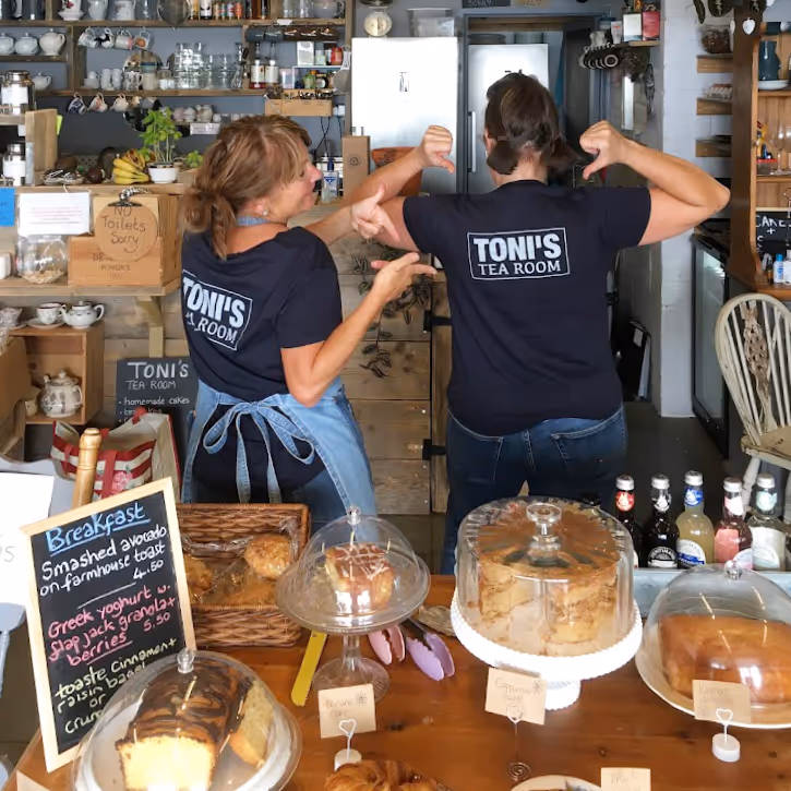 Staff and fresh cakes in a cafe