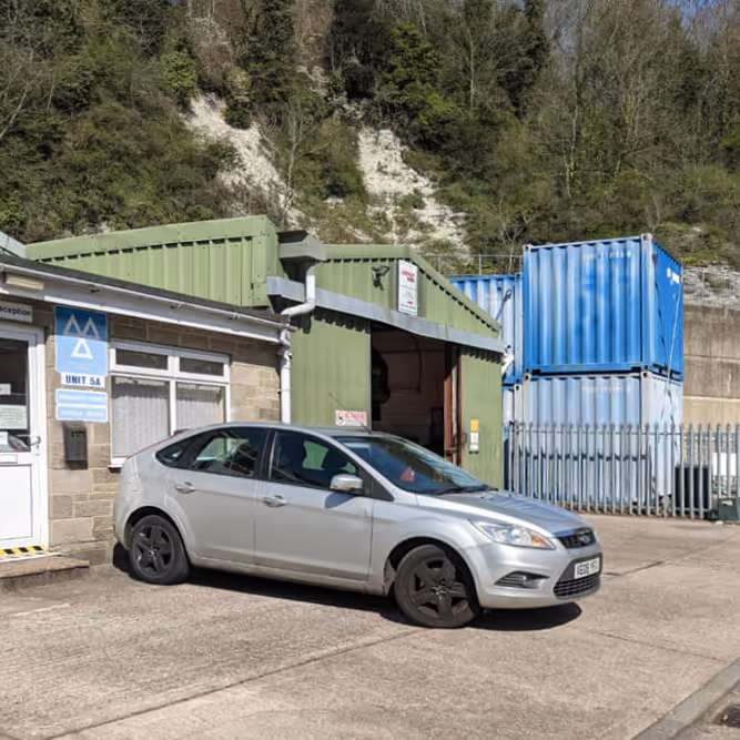 Silver car parked at a garage