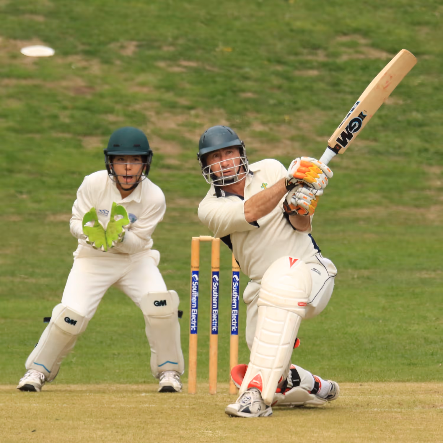 Two men playing cricket