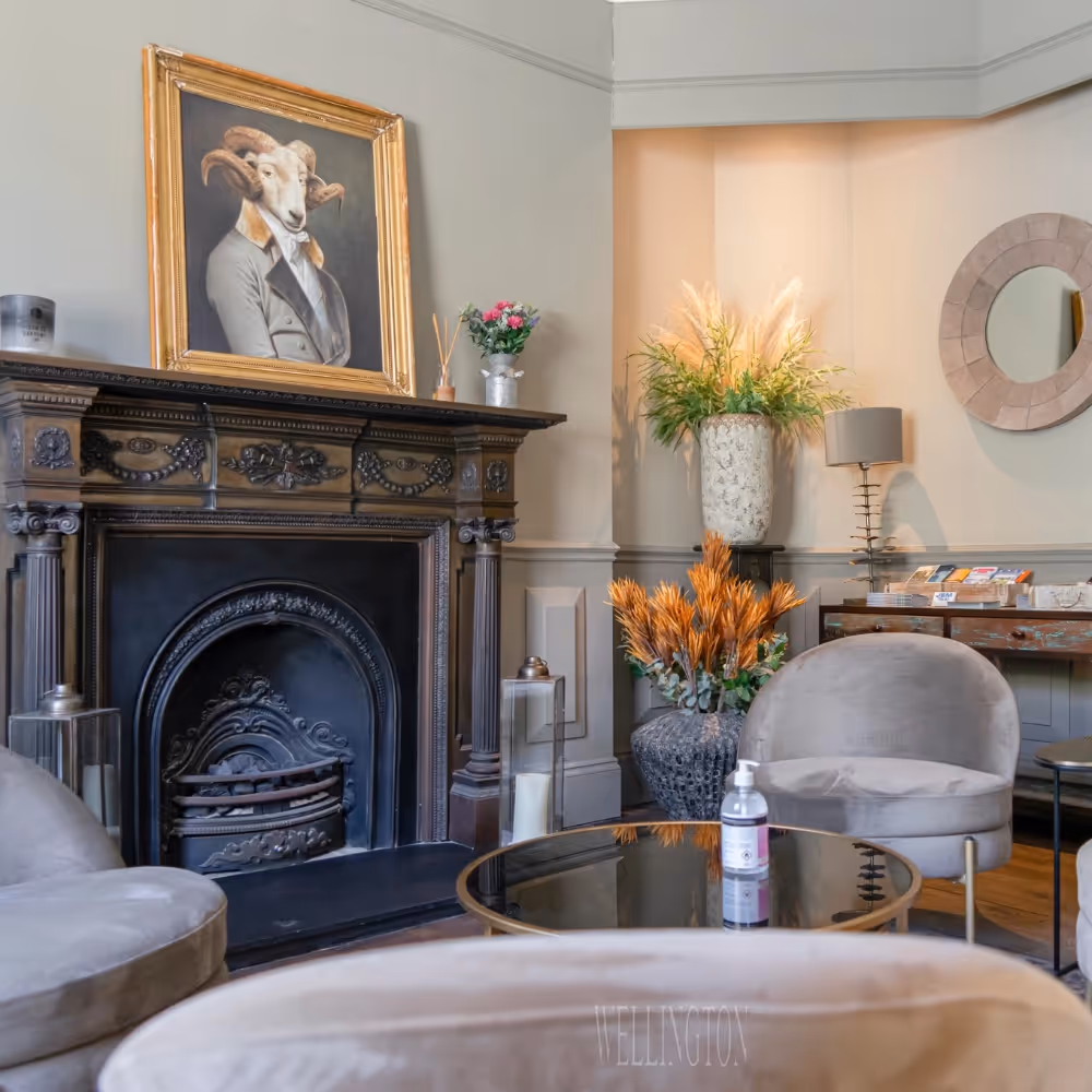 A cosy hotel lounge with traditional fireplace