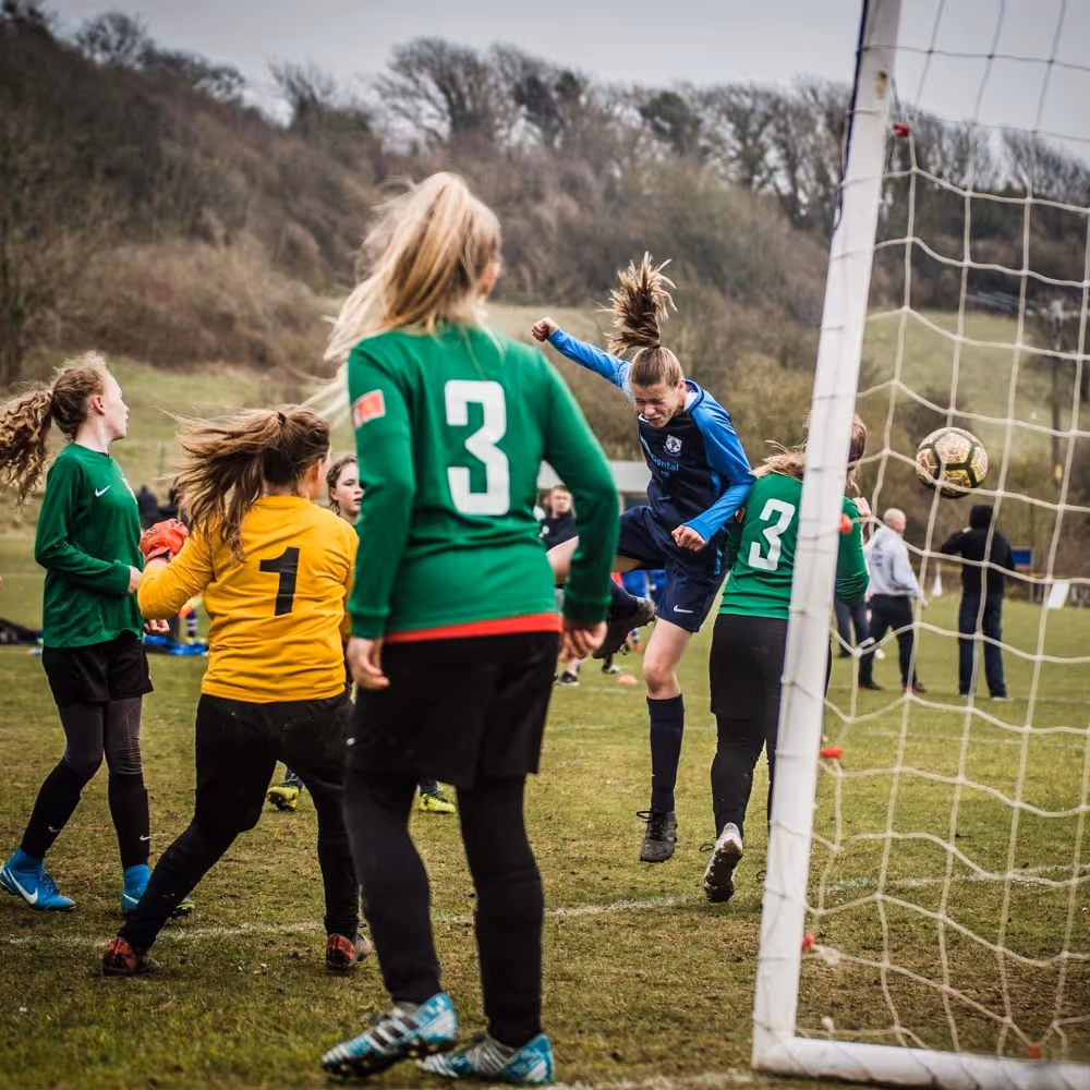 Youth football team about to score a goal