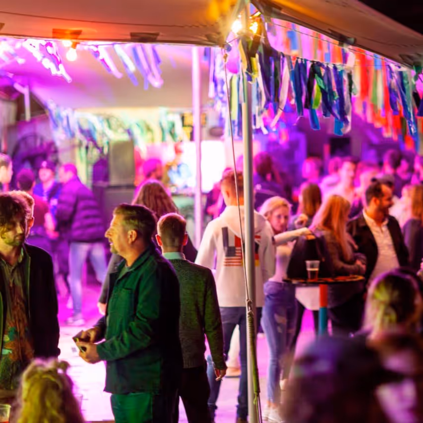 People gathering outside a beer tent at a festival