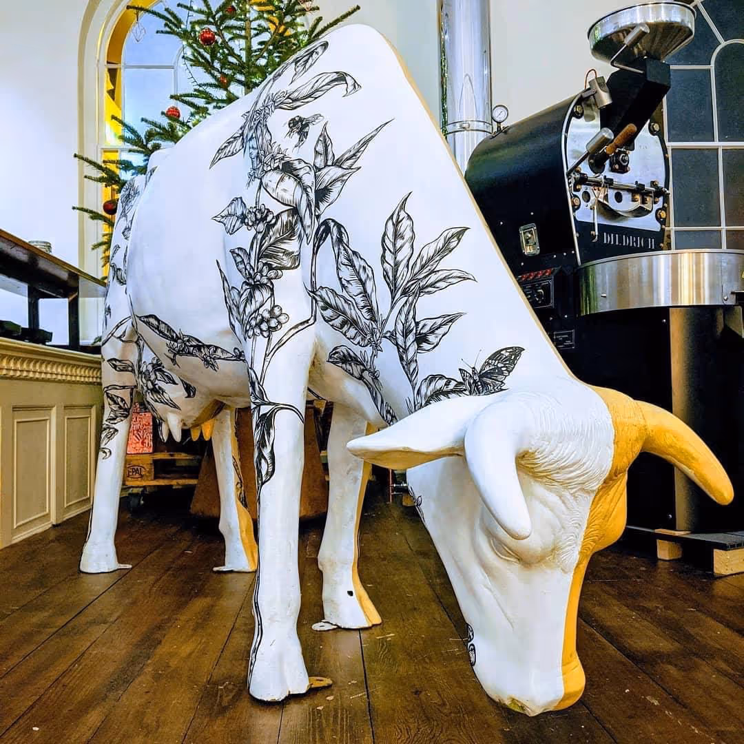 Lifesize model of a cow with black white decoration