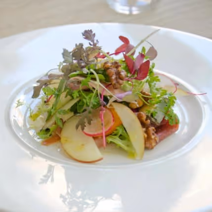 A salad with fresh apple slices