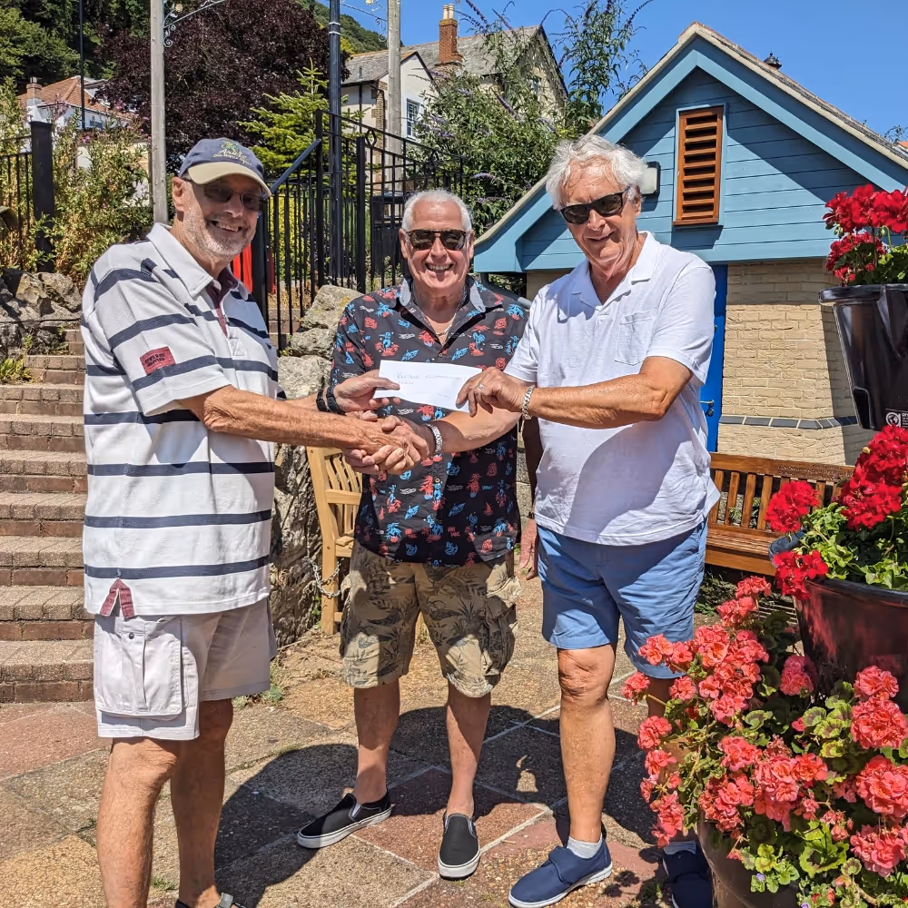 A cheque being presented to a charity