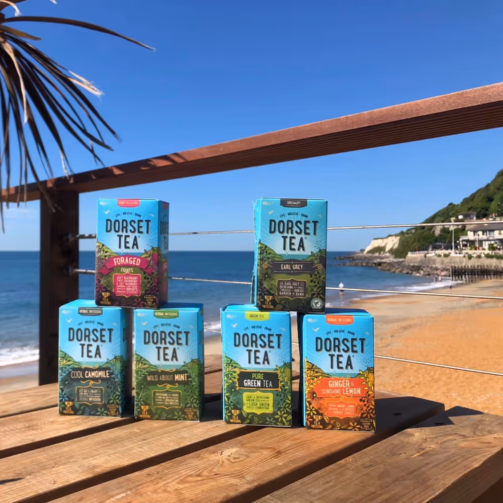 Boxes of tea on a beach-side table
