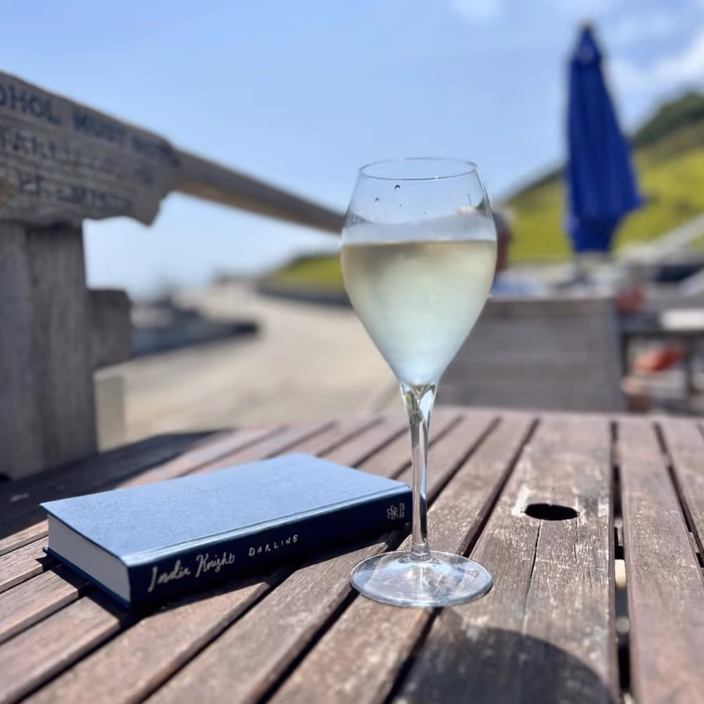 Enjoying a glass of wine and a book