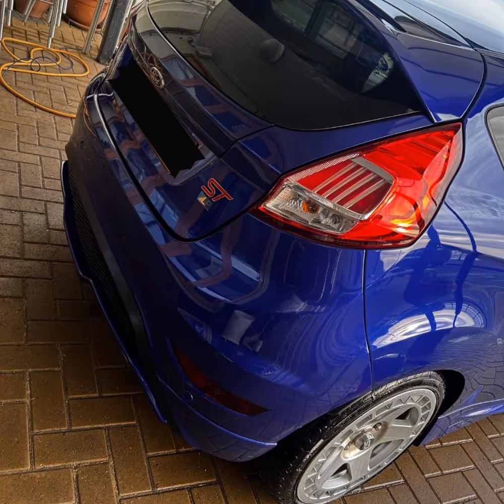 Rear end of a blue hatchback car