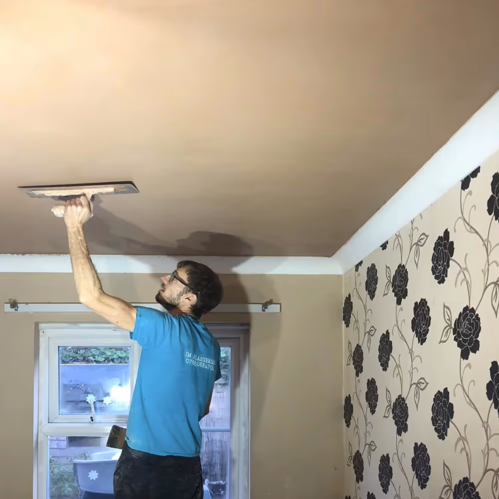 Man plastering a ceiling