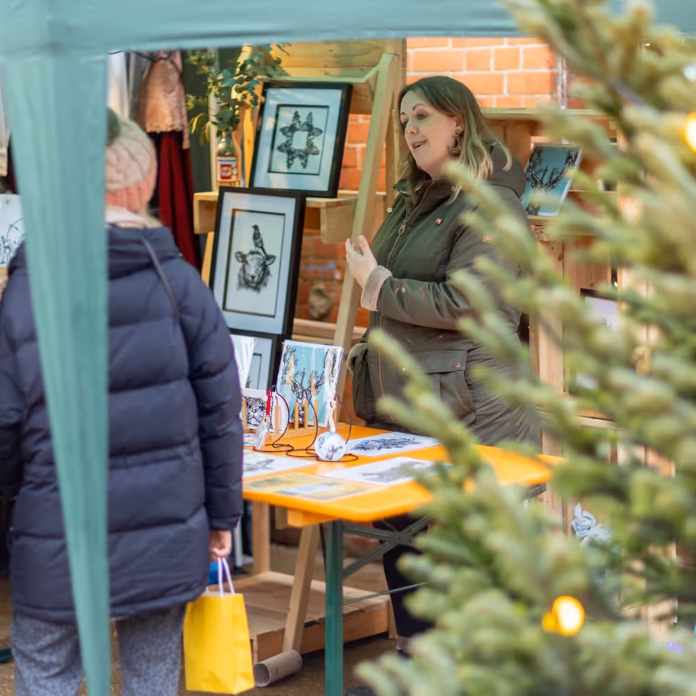 Stall holder talking to customers