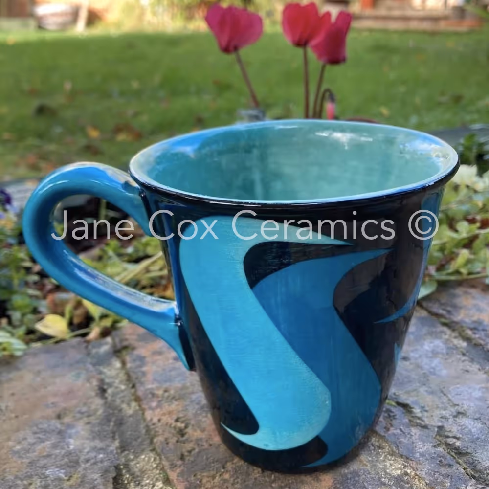 A turquoise and black mug