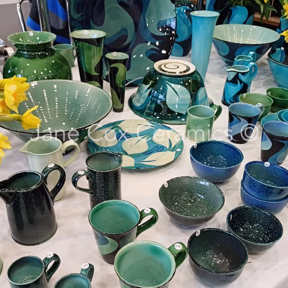 Selection of green and turquoise ceramics on a exhibition stand