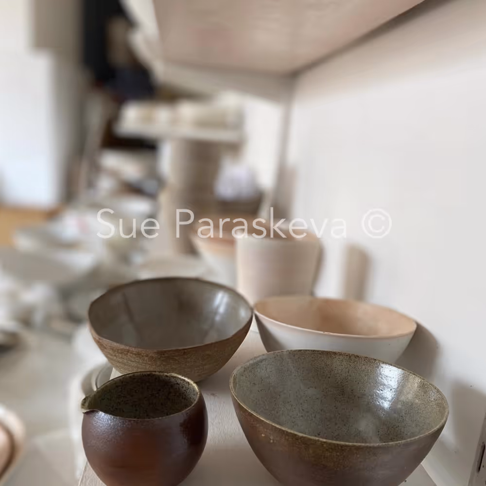 Wood fired porcelain bowls displayed on a shelf
