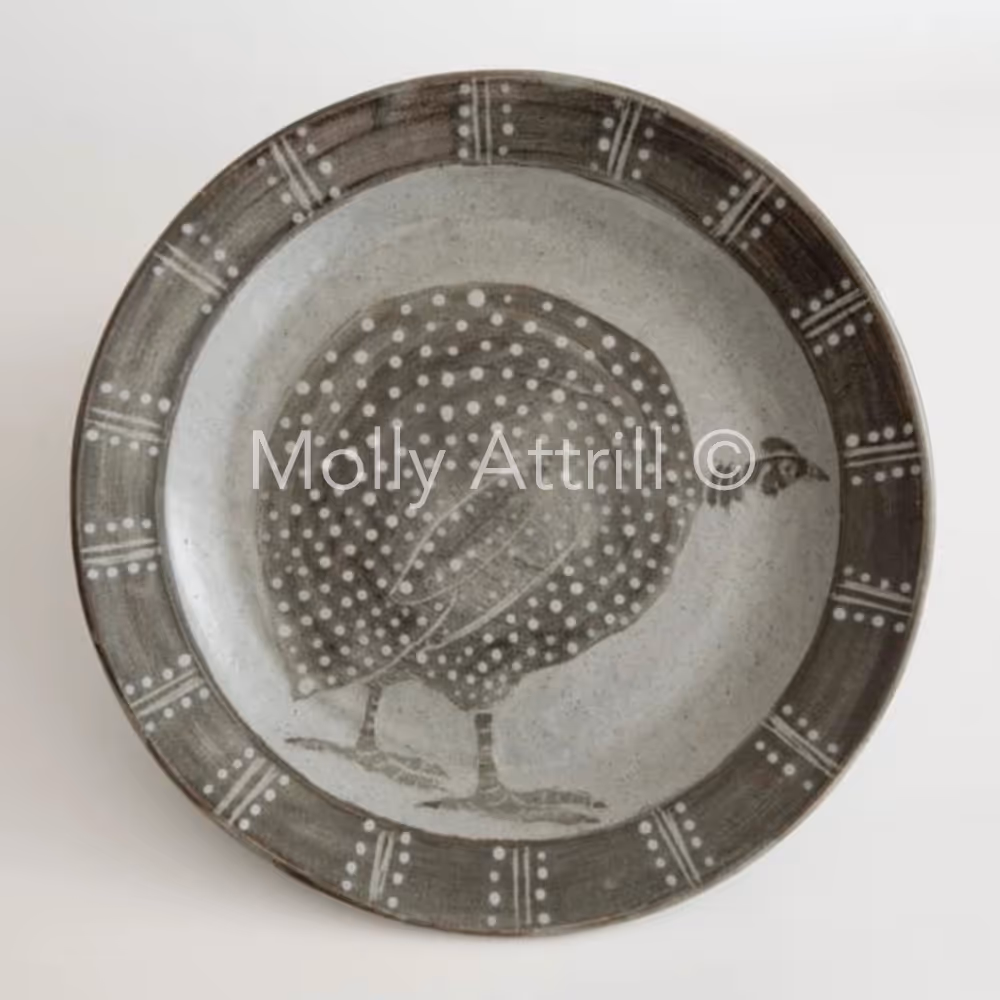 A taupe and white plate with a quail design